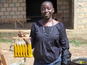 Nialeya village: Candles from surplus beeswax, using candle dipping rack. 